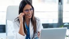 Healthcare professional interacting with a person via a PC