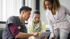 Healthcare professional two people looking at data on a tablet