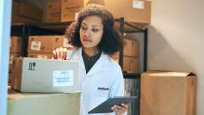 A pharmacist doing stock inventory using a digital tablet