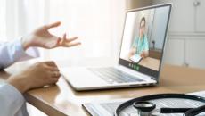 Healthcare provider on a computer talking to someone