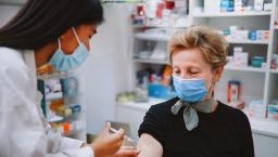 Pharmacist giving a person an injection 