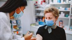 Pharmacist giving a person an injection 