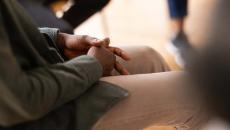 Person sitting in group therapy