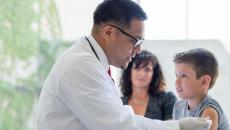 Doctor giving injection to pediatric patient