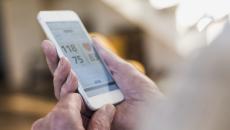 Photo of a smart phone showing blood pressure reading