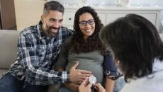 Couple, pregnant women consulting with a healthcare professional