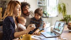 Family communicating with healthcare professional via telehealth