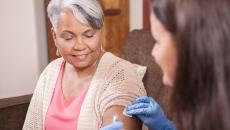 Health care professional administering an injectable medication