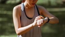 A runner checking on their smartwatch
