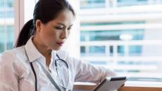 Healthcare practitioner reviewing EMR
