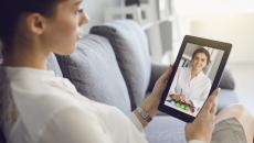 Person interacting with a healthcare professional via tablet