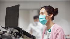 Healthcare professional looking at a computer
