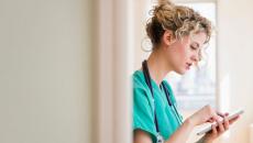 A nurse checking on tasks in their device