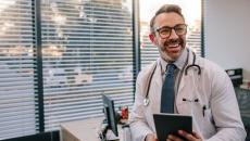 Doctor standing in a room and smiling