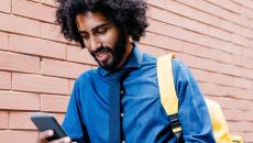Man walking while looking at a phone