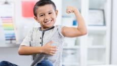 Person sitting in a clinic while flexing their arm muscles