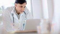 A doctor using a laptop