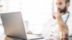 Doctor sitting at a computer